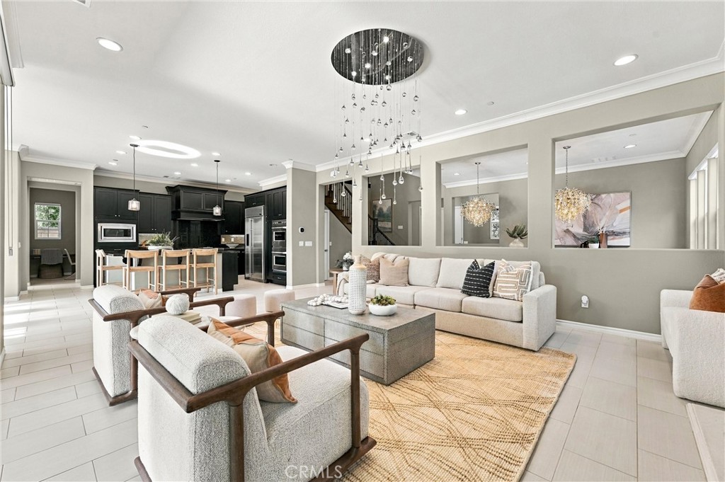 A spacious great room with fireplace, opens to a California room. - 104 Sparrow, Irvine CA 92618 - photo 18