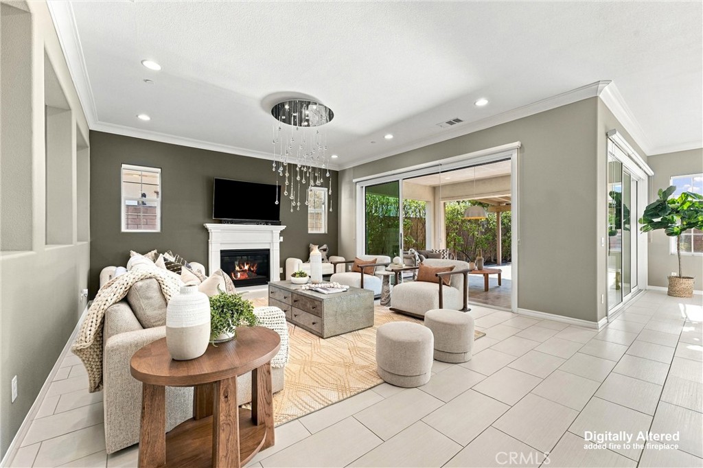 A spacious great room with fireplace, opens to a California room. - 104 Sparrow, Irvine CA 92618 - photo 19