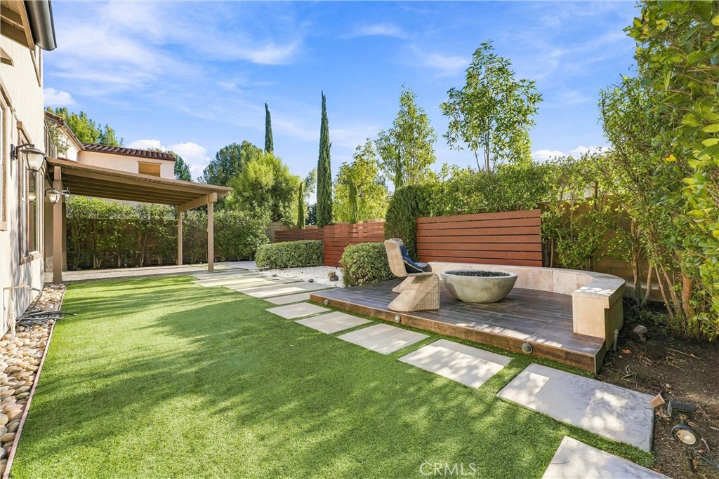 Outdoors, the beautifully landscaped backyard is designed for effortless Southern California living, featuring an expans - 104 Sparrow, Irvine CA 92618 - photo 27