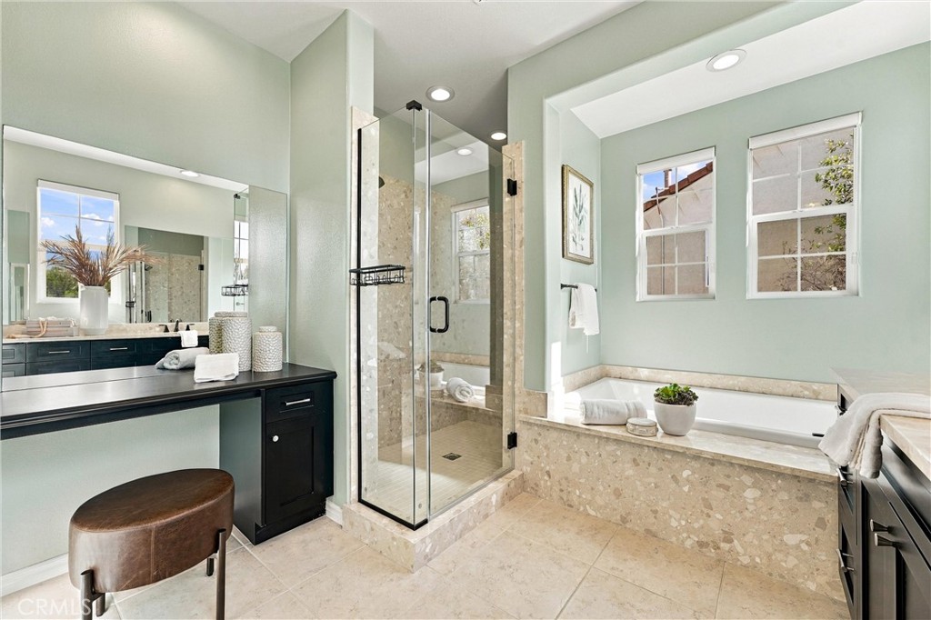 Primary bathroom with soaking tub, separate shower, and dual vanities. - 104 Sparrow, Irvine CA 92618 - photo 45