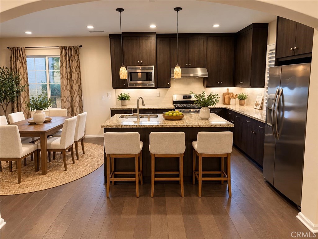 Virtually staged - Kitchen and Dining area. - 104 Strawberry Grove, Irvine CA 92620 - photo 2