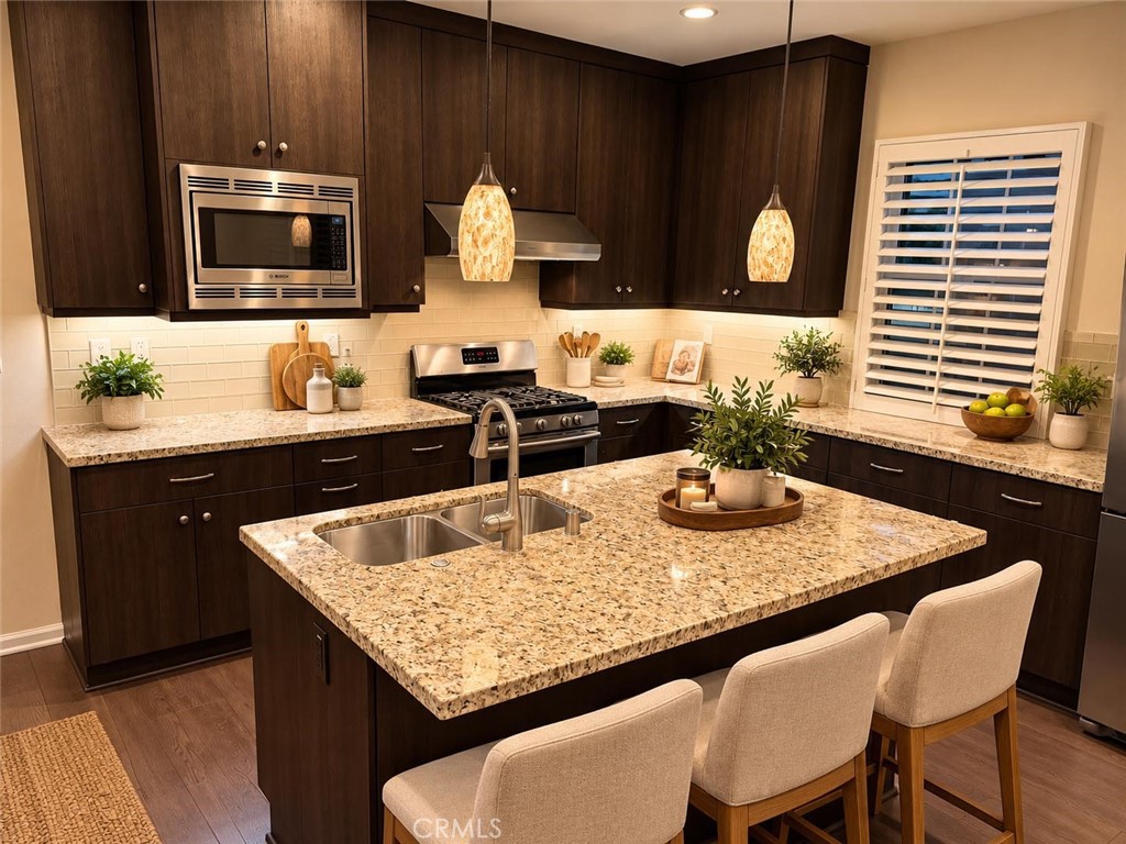 Virtually staged - Kitchen with quality stainless steel appliances. - 104 Strawberry Grove, Irvine CA 92620 - photo 3