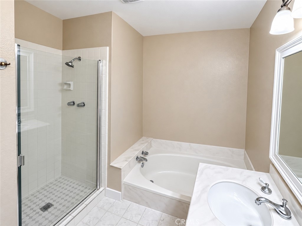 Primary bathroom soaking tub and shower - 11 Beechwood, Irvine CA 92604 - photo 15