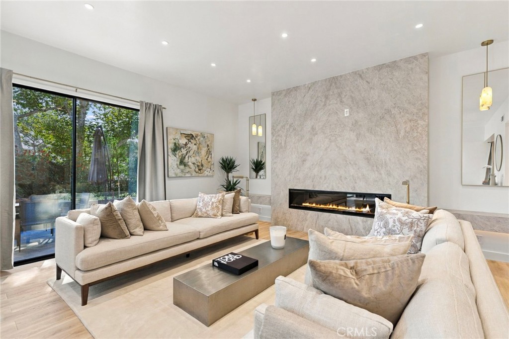 Seamless access to the beautiful outdoor patio from the living room - 11 Palos 55, Irvine CA 92612 - photo 4