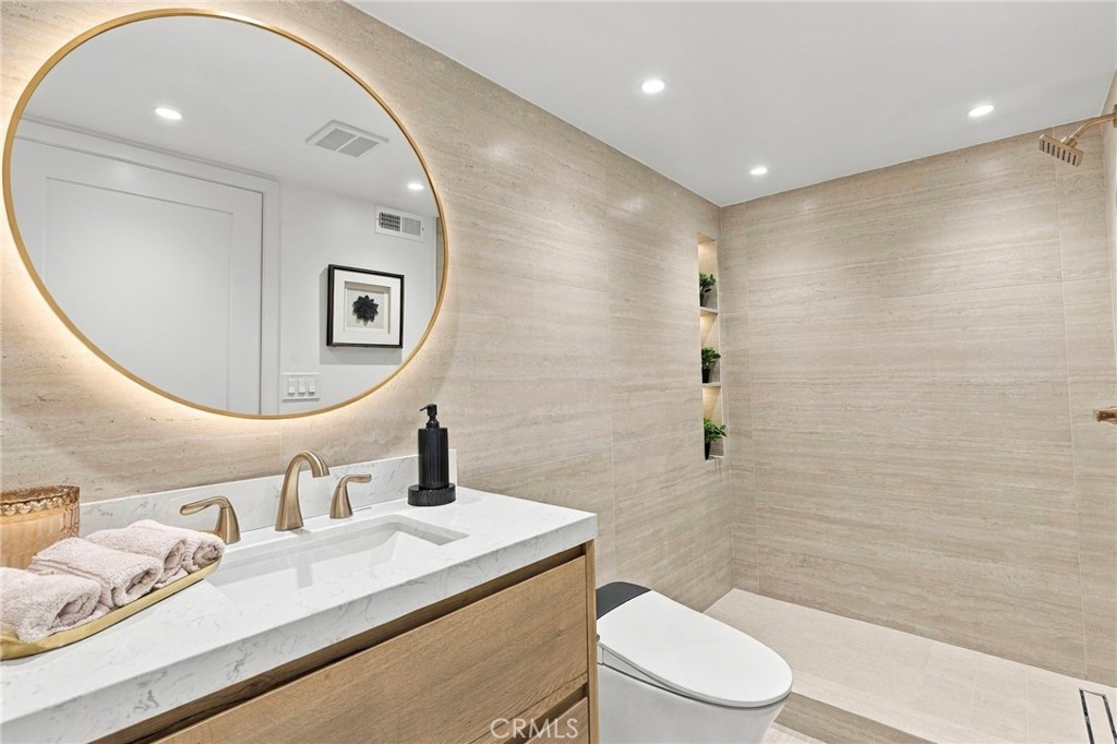Completely renovated bathroom with stone countertops and smart features - 11 Palos 55, Irvine CA 92612 - photo 16