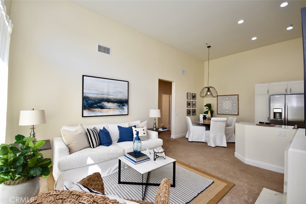 Spacious living room with new carpet and high ceilings. - 1103 Solvay Aisle, Irvine CA 92606 - photo 4