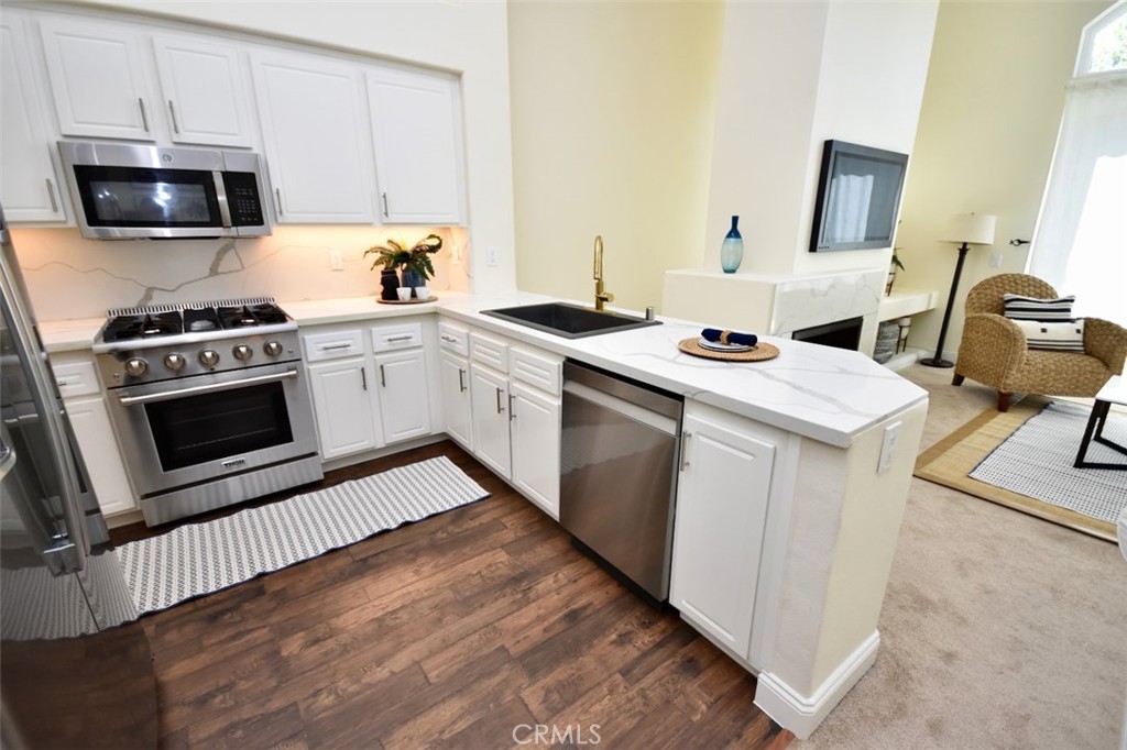 Beautifully remodeled kitchen with newer stainless steel appliances approx. 1 year old. - 1103 Solvay Aisle, Irvine CA 92606 - photo 10