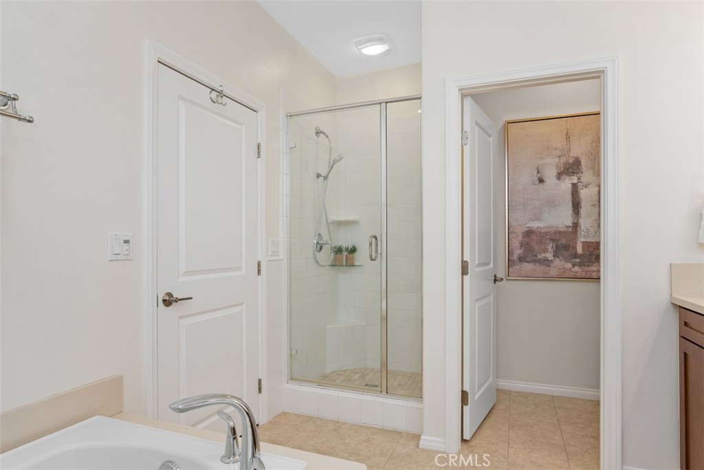 Primary bath offers a walk-in shower and a separate bathtub. - 117 Gemstone, Irvine CA 92620 - photo 17