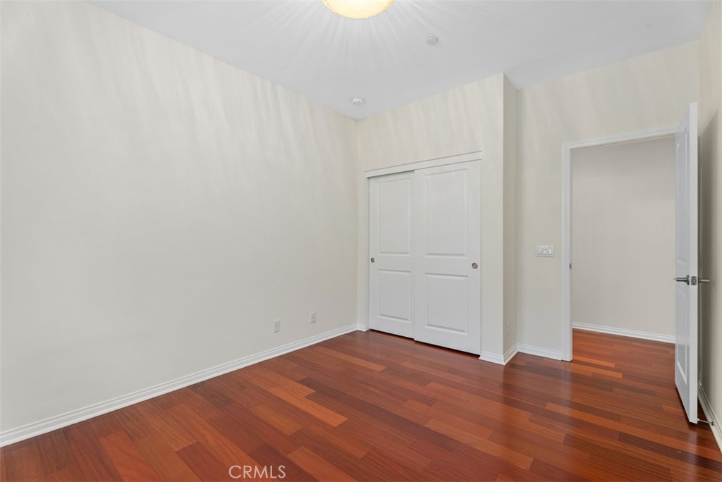 Third bedroom with hardwood floors and closet. - 117 Gemstone, Irvine CA 92620 - photo 22