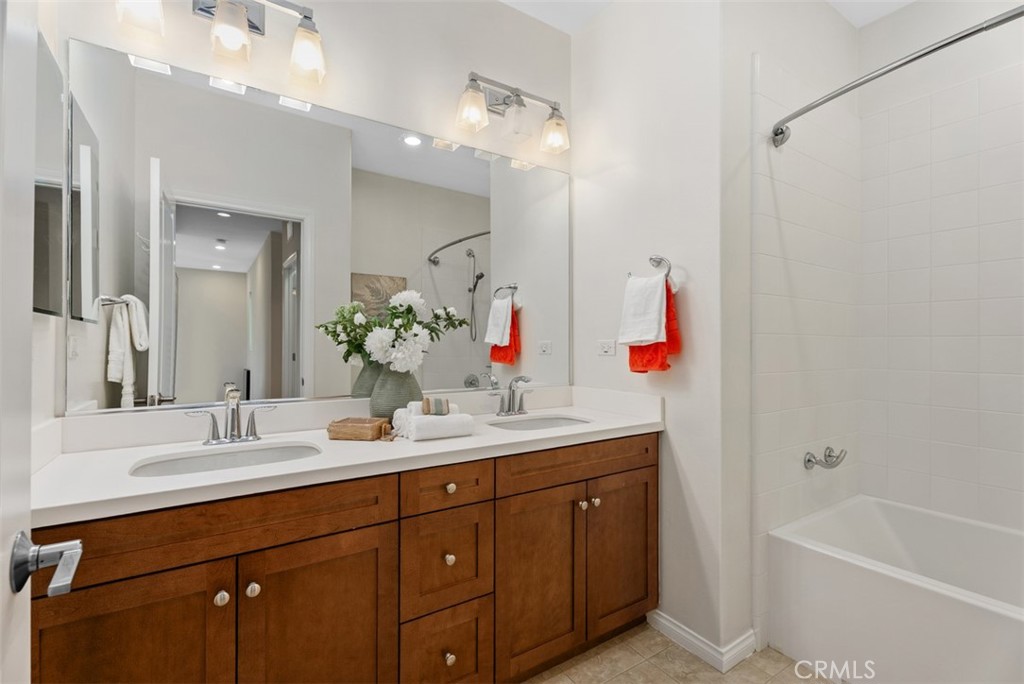 Full bathroom upstairs with dual sinks and bathtub. - 117 Gemstone, Irvine CA 92620 - photo 23