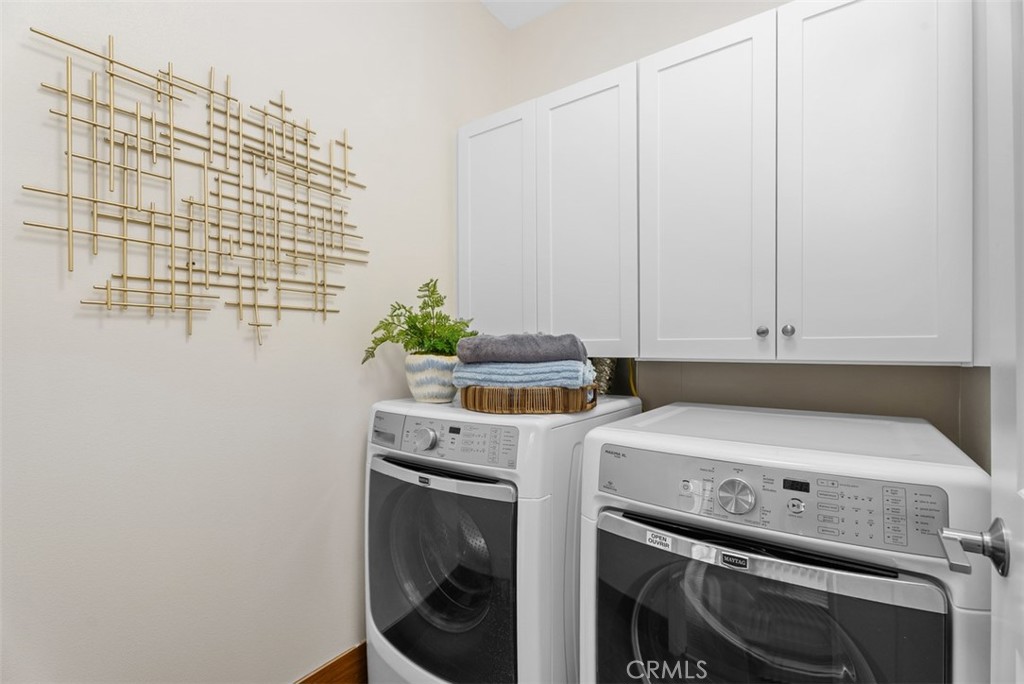 Individual laundry room with linen cabinetry. - 117 Gemstone, Irvine CA 92620 - photo 25