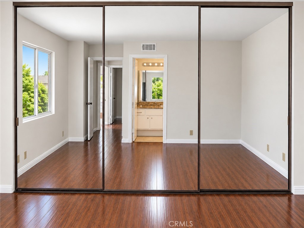 Primary bedroom with glass mirror wardrobe - 12 Spring Buck, Irvine CA 92614 - photo 5
