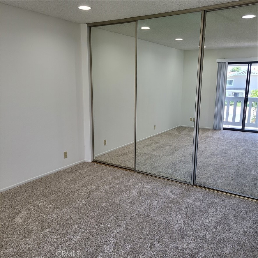 Primary bedroom with mirrored wardrobe doors - 125 Tarocco, Irvine CA 92618 - photo 14
