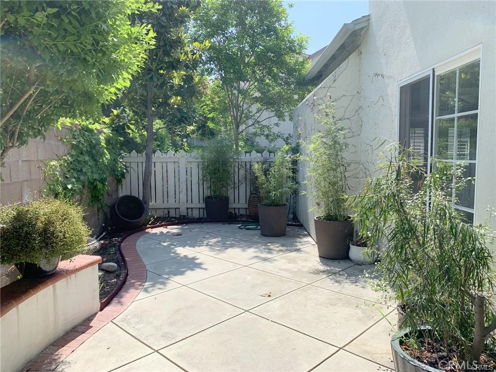 Spacious and private patio yard accessible through the sliding glass door in kitchen or the gate in back - 126 Winslow Lane, Irvine CA 92620 - photo 11