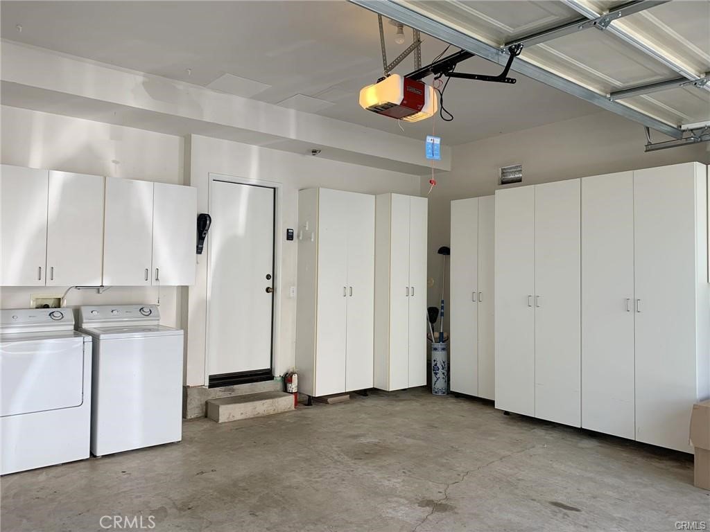 Two car garage with tons of storage cabinets. Washer and Dryer included for your use. - 126 Winslow Lane, Irvine CA 92620 - photo 12