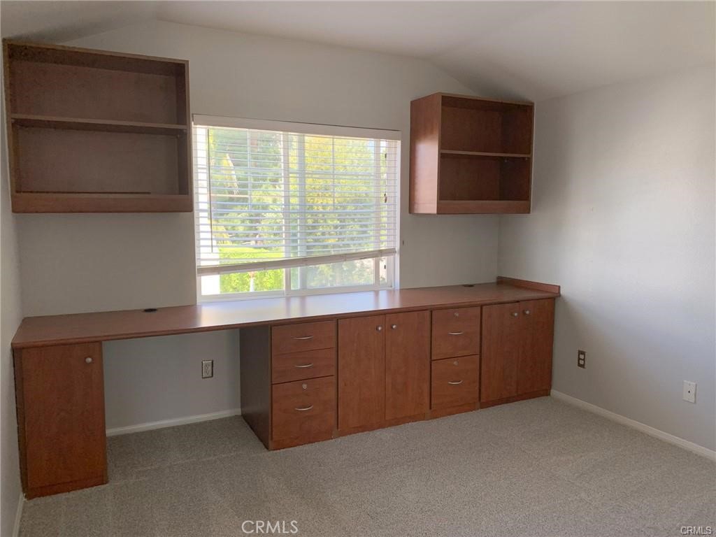 Second bedroom with built in desk and cabinets. - 126 Winslow Lane, Irvine CA 92620 - photo 14