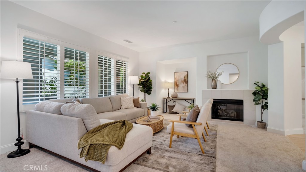 Expansive living area with plantation shutters and new designer carpet. - 128 Talmadge, Irvine CA 92602 - photo 5