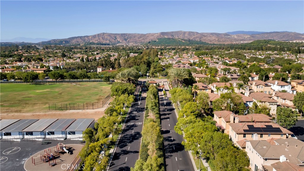 Grand entrance to the village featuring scenic landscaping and welcoming architecture. - 128 Talmadge, Irvine CA 92602 - photo 31