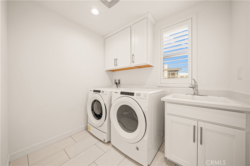 SEPARATE LAUNDRY ROOM WITH SINK & CABINETS complete the second level. - 136 Episode, Irvine CA 92618 - photo 44
