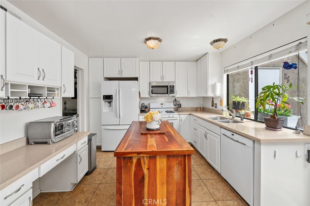 Updated kitchen with quartz countertops, center island, and generous cabinet storage. - 14 Greenleaf, Irvine CA 92604 - photo 12