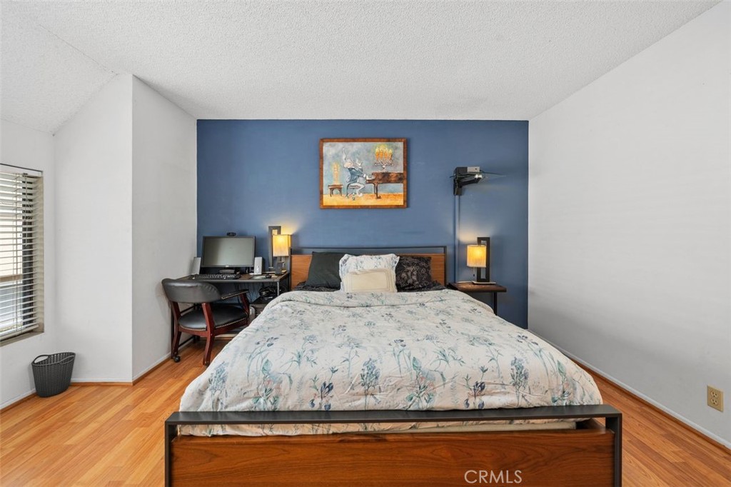 Primary bedroom with walk-in closet and space for a home workspace. - 14 Greenleaf, Irvine CA 92604 - photo 19