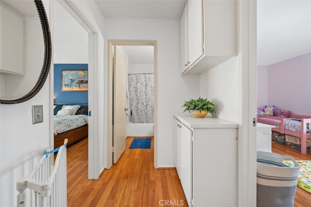 Upstairs hallway with built-in linen cabinet and additional storage. - 14 Greenleaf, Irvine CA 92604 - photo 23