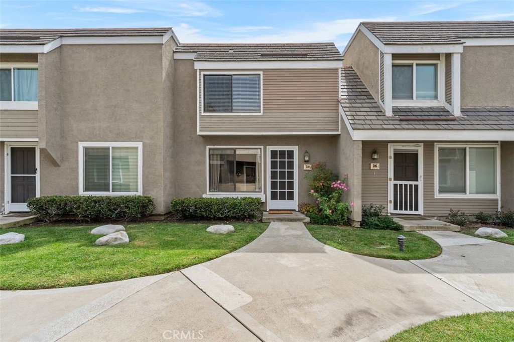 Exterior view of the Woodbridge townhome and landscaped surroundings. - 14 Greenleaf, Irvine CA 92604 - photo 34