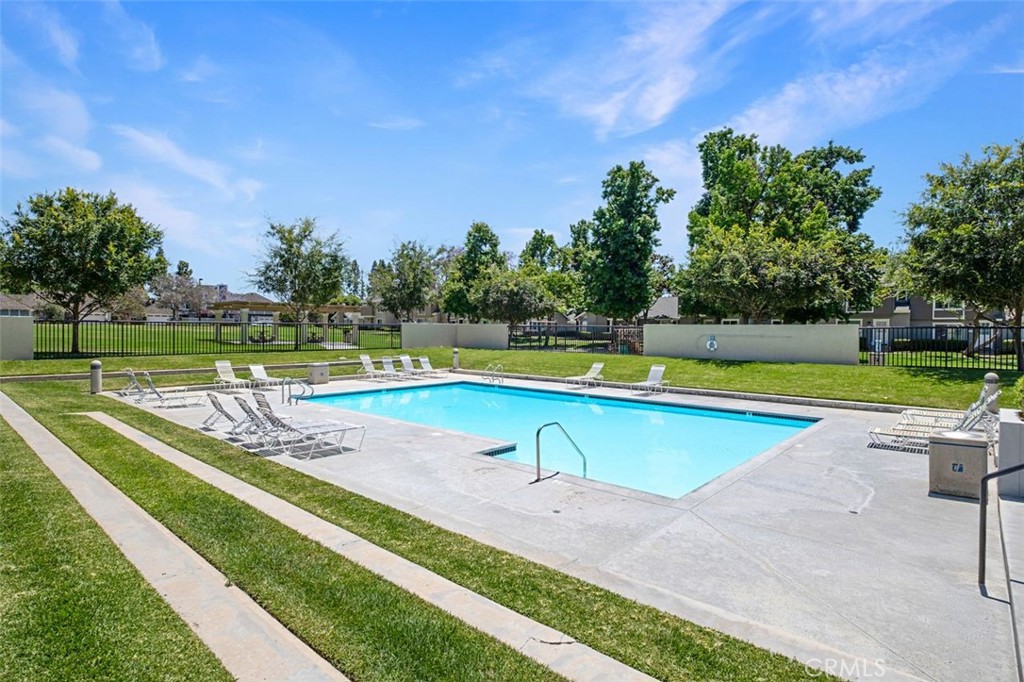 Community swimming pool surrounded by landscaped green space. - 14 Greenleaf, Irvine CA 92604 - photo 42