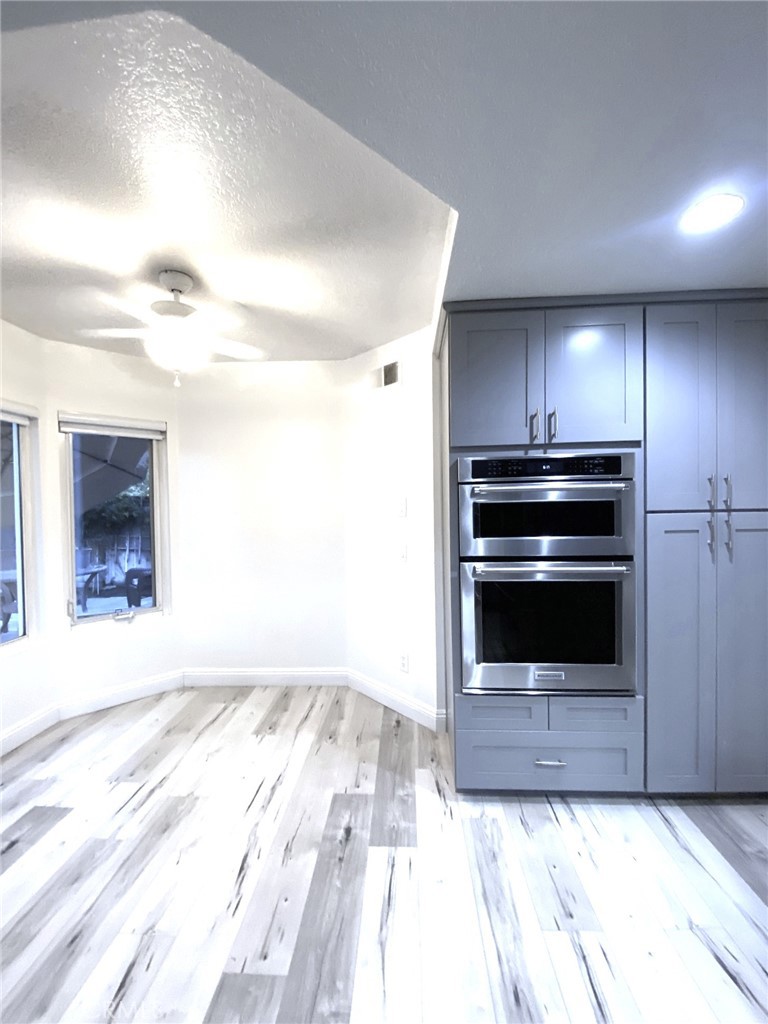 More cabinets and built-in microwave and convection oven. Breakfast nook - 14 Rainbow Lk 3, Irvine CA 92614 - photo 11