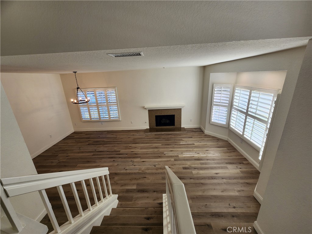 Down view of living room from the stairs. - 168 Greenmoor 72, Irvine CA 92614 - photo 6