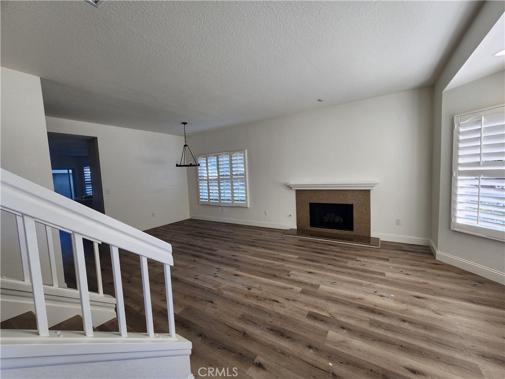 Down view of living room from the stairs. - 168 Greenmoor 72, Irvine CA 92614 - photo 7