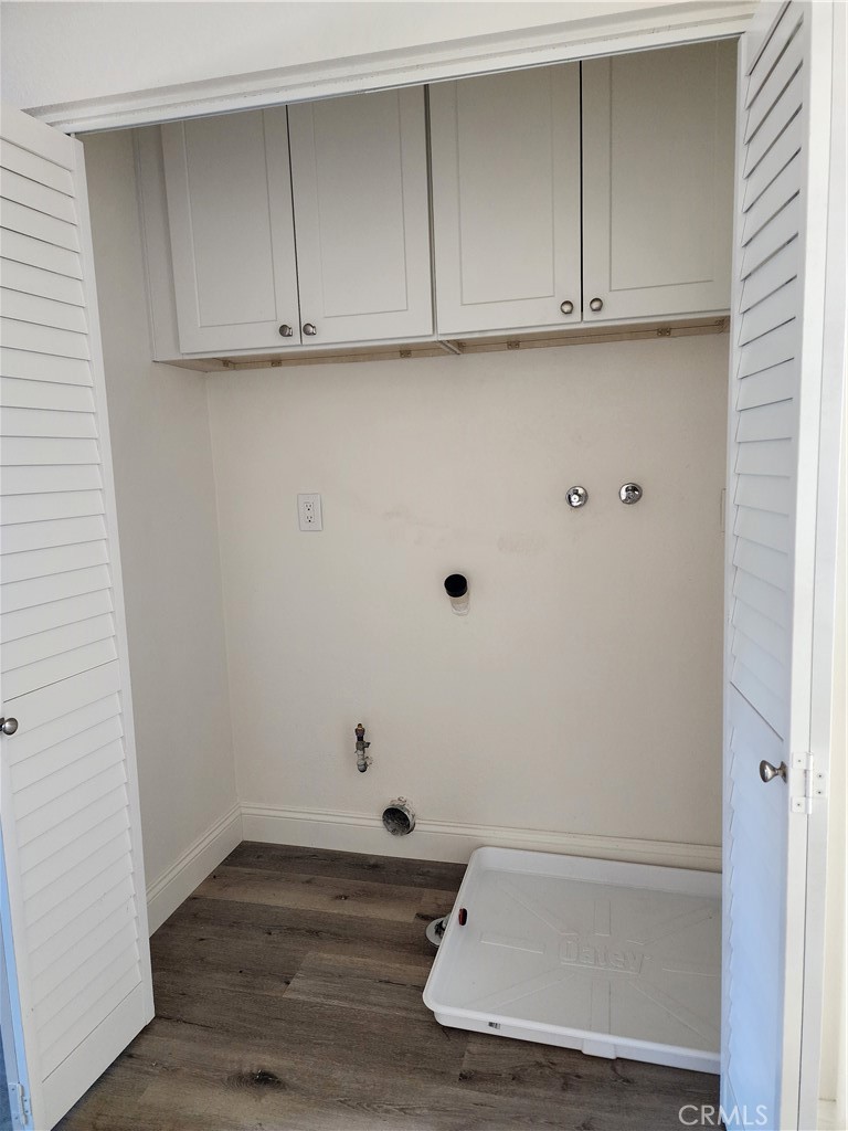 Washer and Dryer hookups in upstairs hallway closet with cabinets - 168 Greenmoor 72, Irvine CA 92614 - photo 27