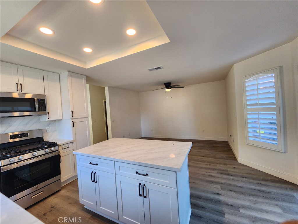 Kitchen adjacent to family room. - 168 Greenmoor 72, Irvine CA 92614 - photo 32