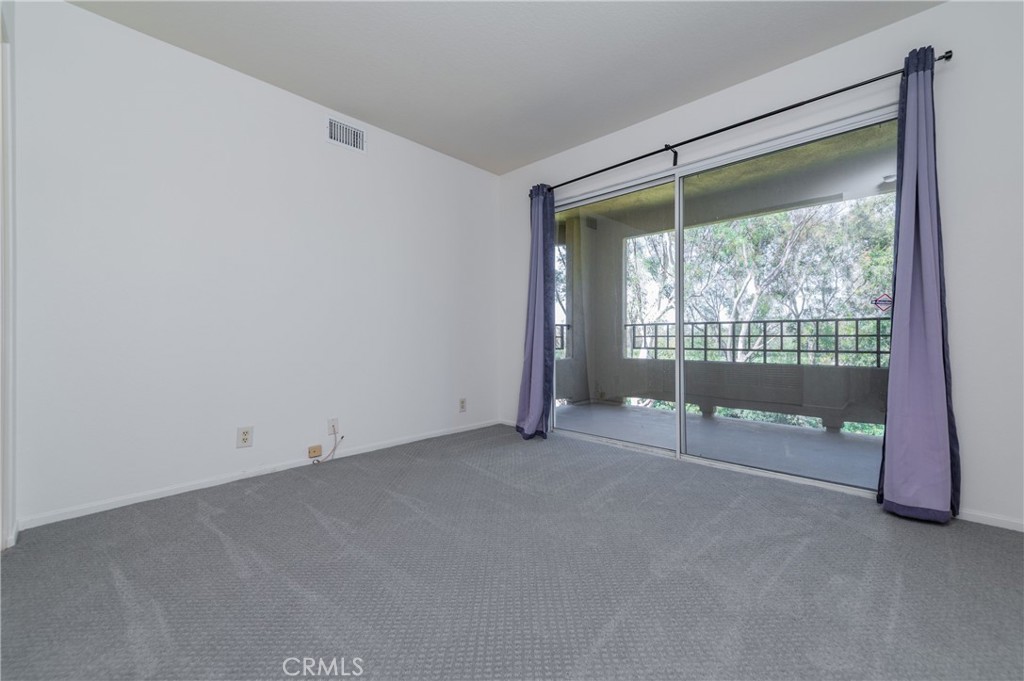 Bedroom 1 with big balcony - 17 Auburn Aisle, Irvine CA 92612 - photo 7