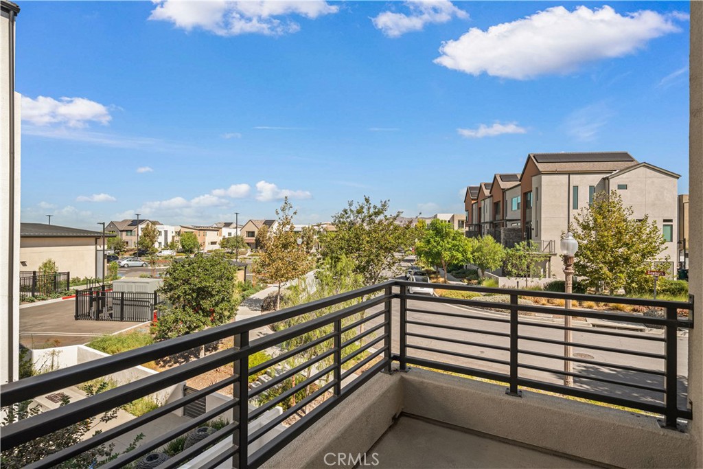 The master suite opens to a balcony perfect for morning coffee and distant mountain views. - 187 Sawbuck, Irvine CA 92618 - photo 35