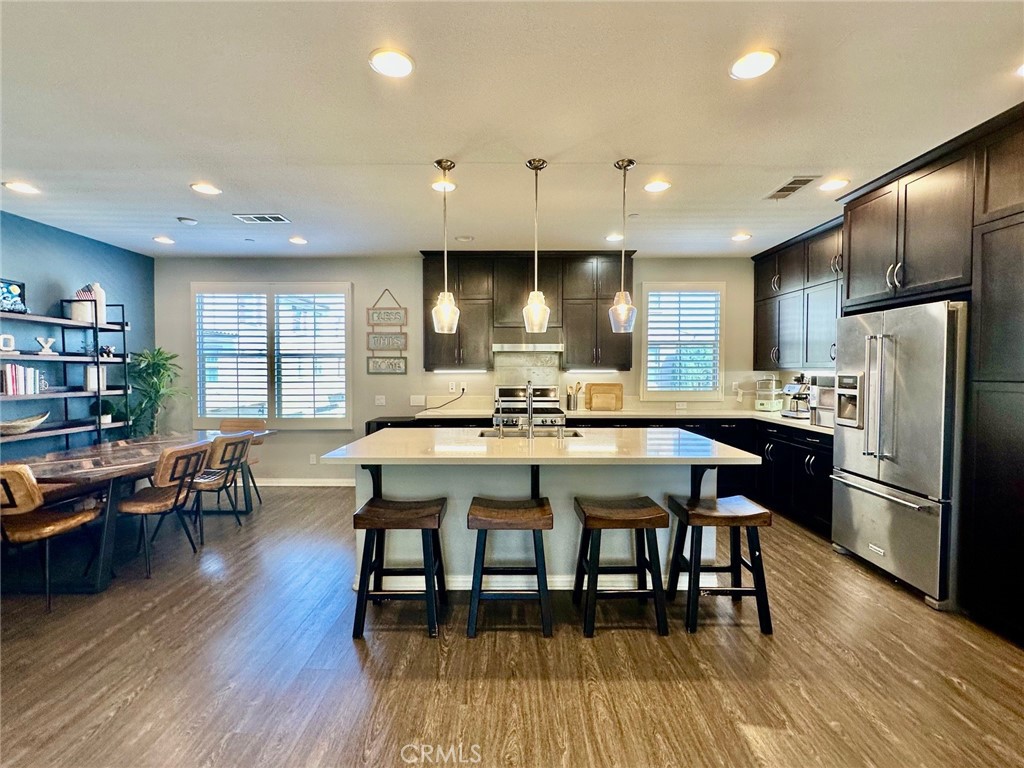 The view of the beautiful modern kitchen with upgraded flooring, stylish cabinets, stainless steel appliances and Quartz - 188 Capricorn, Irvine CA 92618 - photo 1