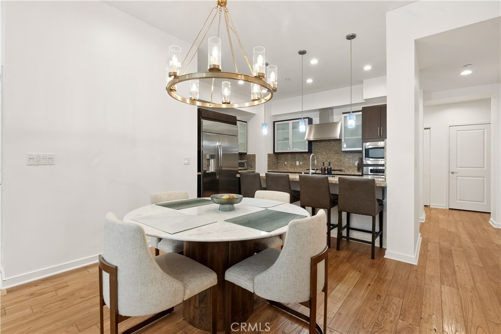 Elegant dining space seamlessly connected to the kitchen and living areas for easy entertaining. - 21 Gramercy 102, Irvine CA 92612 - photo 2