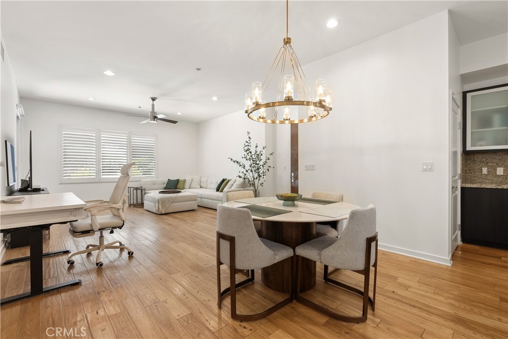 Light filled dining area with stylish lighting and an open flow throughout the main living spaces. - 21 Gramercy 102, Irvine CA 92612 - photo 3
