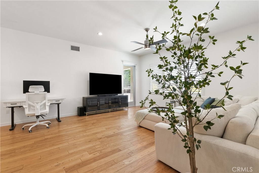 Bright and welcoming enterance with soaring ceilings, warm wood flooring, and abundant natural light. - 21 Gramercy 102, Irvine CA 92612 - photo 4