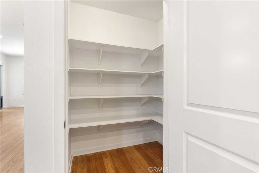 Walk in pantry offering exceptional kitchen storage and everyday convenience. - 21 Gramercy 102, Irvine CA 92612 - photo 10