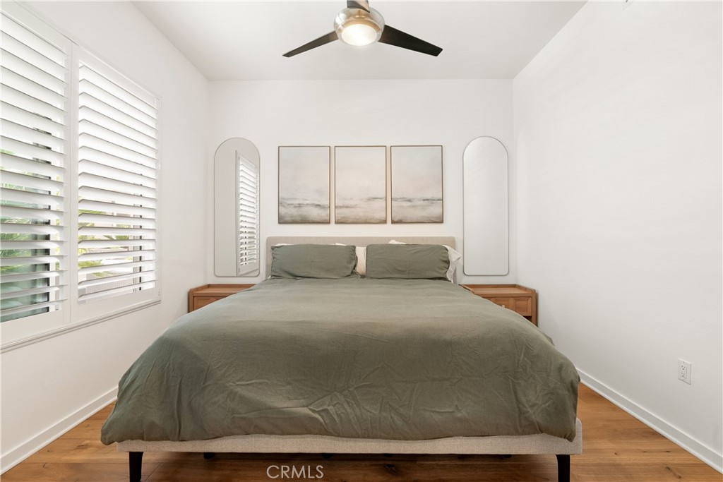 Comfortable secondary bedroom with modern ceiling fan and plenty of natural light. - 21 Gramercy 102, Irvine CA 92612 - photo 11