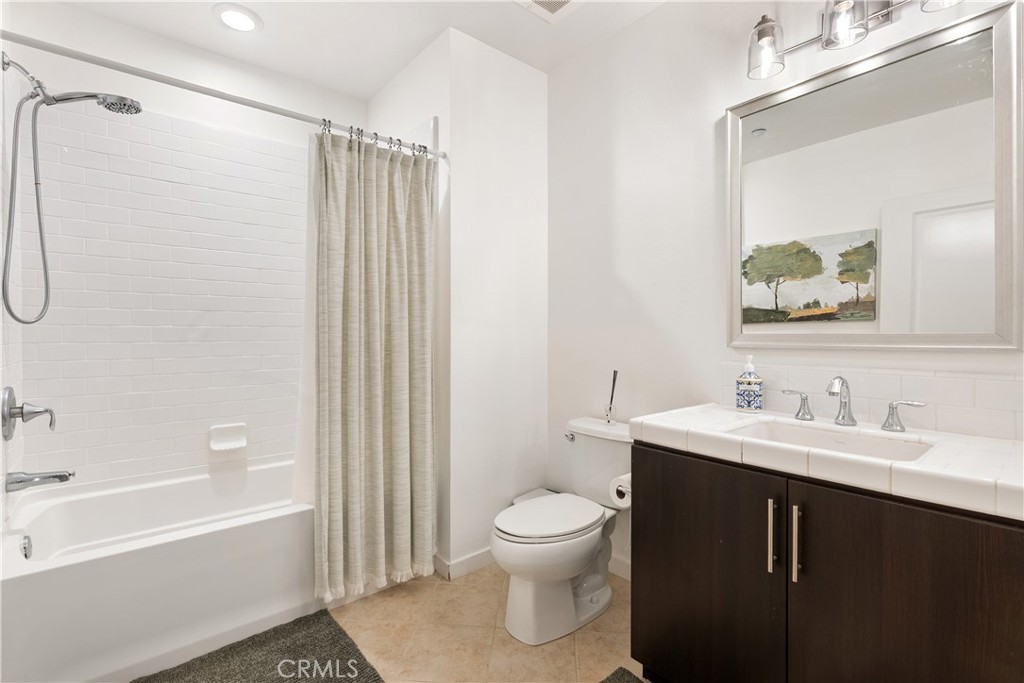 Spa inspired bathroom featuring dual sinks, modern finishes, and generous counter space. - 21 Gramercy 102, Irvine CA 92612 - photo 14