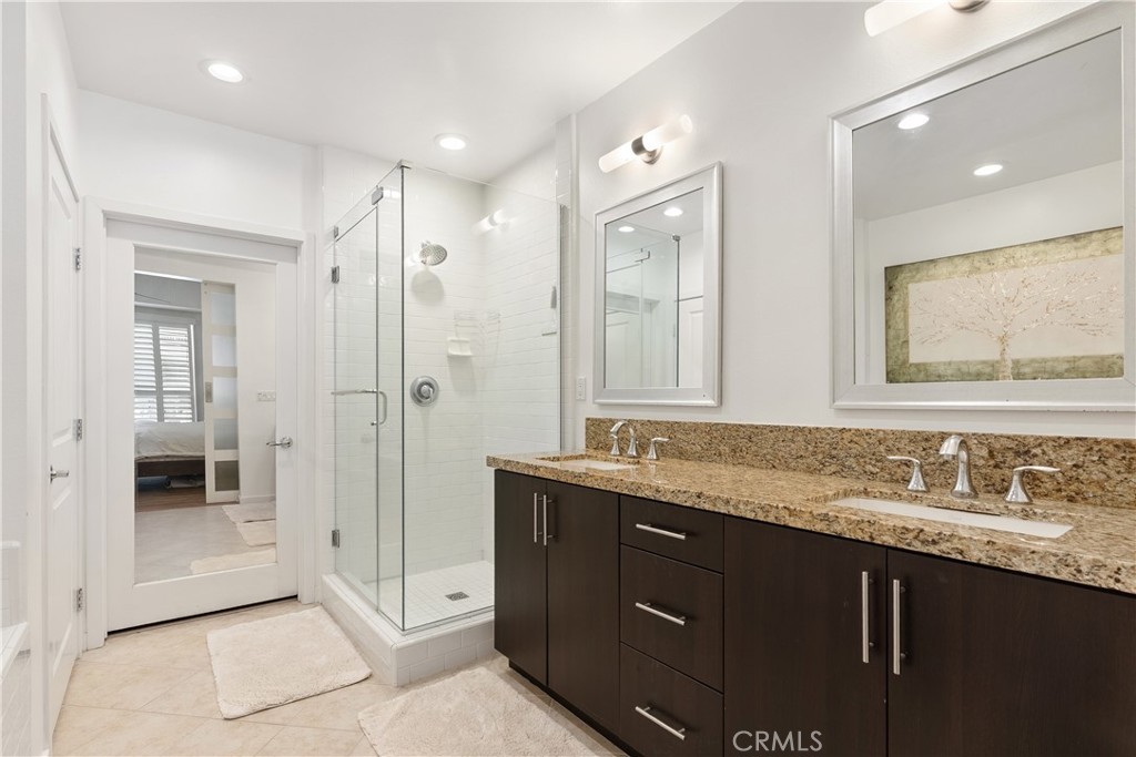 Beautifully appointed primary bath with oversized vanity and elegant finishes throughout. - 21 Gramercy 102, Irvine CA 92612 - photo 17