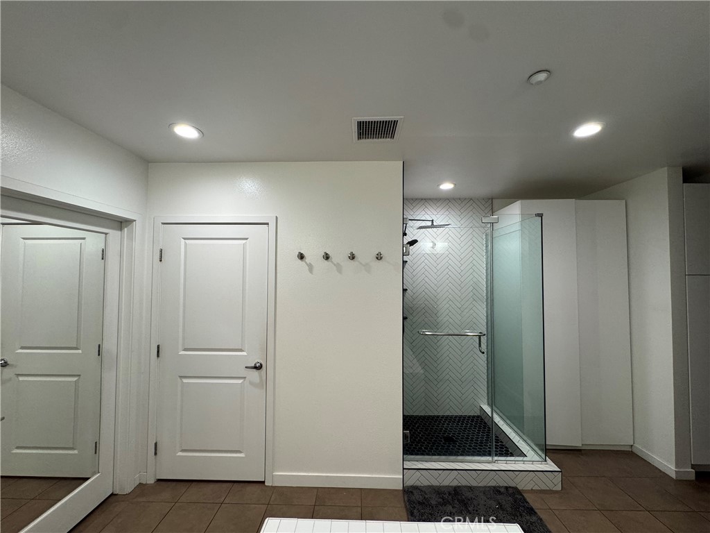Toilet with a privacy door, and a large walk in closet with custom made closet organizer. - 21 Gramercy 218, Irvine CA 92612 - photo 27