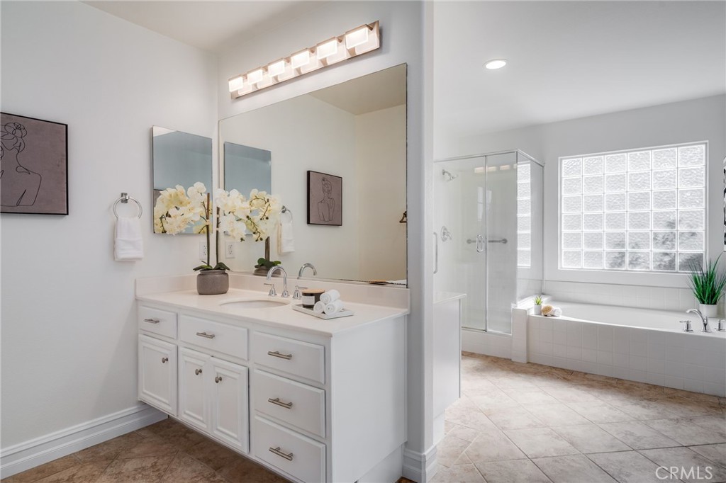 Primary bathroom includes dual vanities, tub, shower and walk-in closet. - 21 Rhode Island, Irvine CA 92606 - photo 21