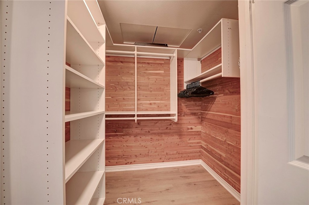 cedar-lined walk-in closet with custom built-ins, shelving, and hanging space. - 2243 Martin 314, Irvine CA 92612 - photo 22