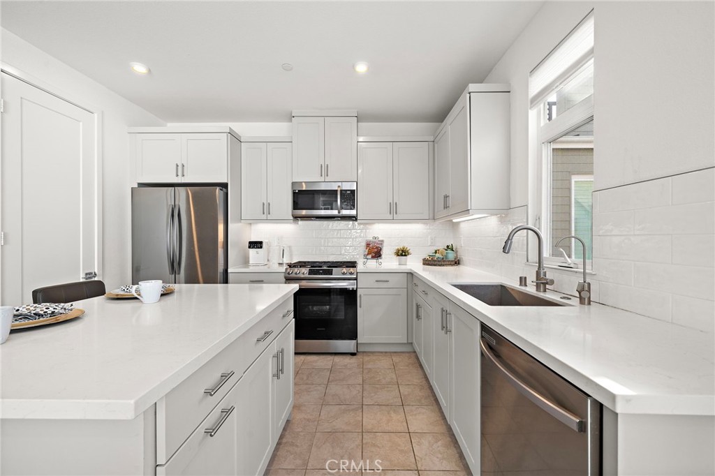 Soft-closing white shaker cabinetry, deep stainless sink, step-in pantry - 230 Abacus, Irvine CA 92618 - photo 13
