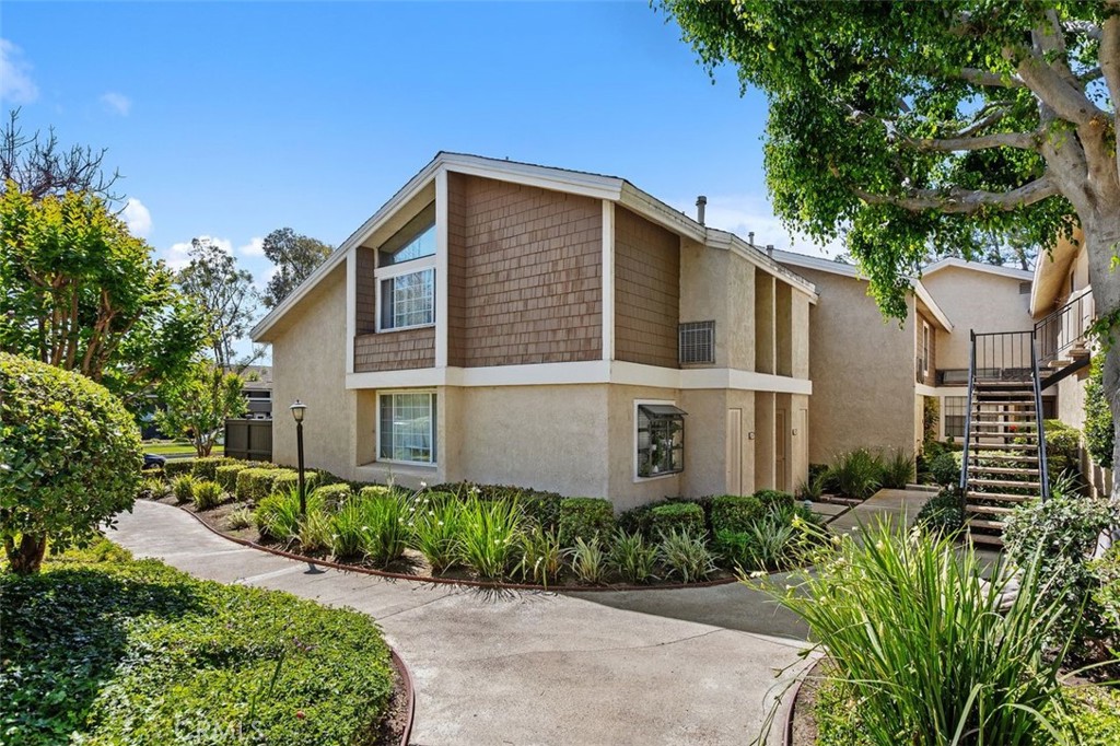 Exterior Front – Welcoming front elevation framed by mature landscaping and a private entry walkway. - 26 Lakepines, Irvine CA 92620 - photo 1