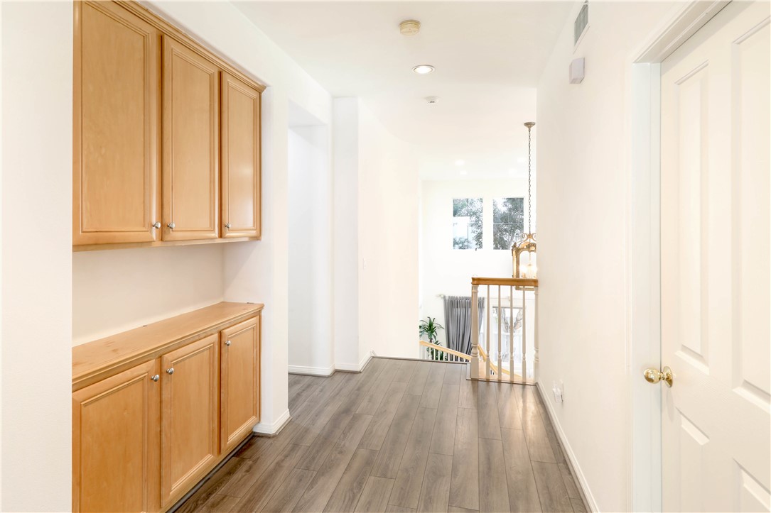 Second level hallway with built-in cabinets - 27 Vienne, Irvine CA 92606 - photo 20