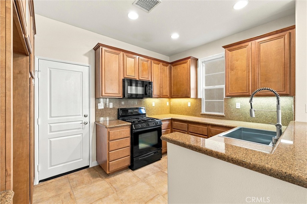 Kitchen with stainless steel appliances - 301 Tall Oak, Irvine CA 92603 - photo 15